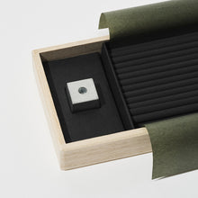 Load image into Gallery viewer, Wooden jewelry box with a black interior, containing a silver ring and green tissue paper.
