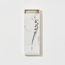 Load image into Gallery viewer, A box of incense sticks with a white label, showing smoke trails indicating the burning of incense.
