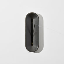Load image into Gallery viewer, A black porcelain incense burner with a modern design, featuring a narrow opening from which an incense stick partially protrudes.
